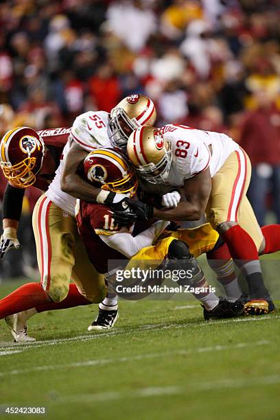 Ahmad Brooks and Demarcus Dobbs of the San Francisco 49ers sacks Robert Griffin III of the Washington Redskins during the game at FedEx Field on...