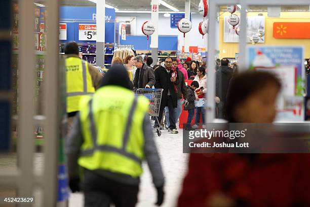 Customers shop at Wal-Mart Thanksgiving day on November 28, 2013 in Troy, Michigan. Black Friday shopping began early this year with most major...