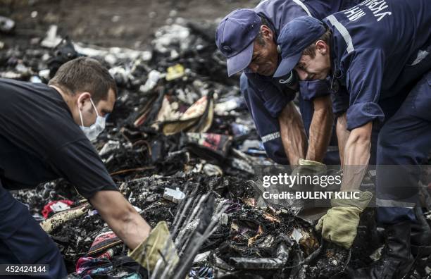 Ukrainian rescue workers search for bodies at the crash site of Malaysia Airlines Flight MH17, near the village of Grabove, in the region of Donetsk...
