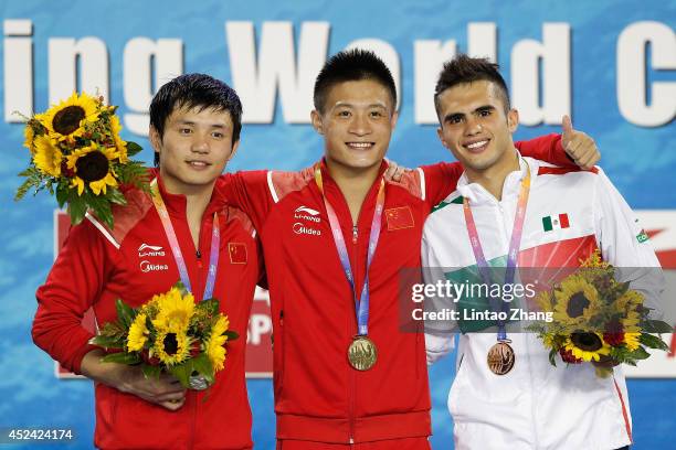 Silver medallist Qiu Bo and gold medallist Yang Jian of China with bronze medallist Ivan Garcia of Mexico celebrate during the medal ceremony for the...