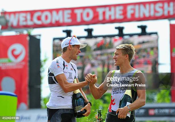 Timo Bracht of Germany shakes hands with second placed Nils Frommhold of Germany after winning the Challenge Roth on July 20, 2014 in Roth, Germany.