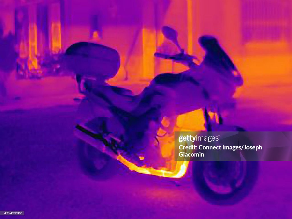 Thermal photograph of motorcycle showing heat of engine, radiator and exhaust pipe