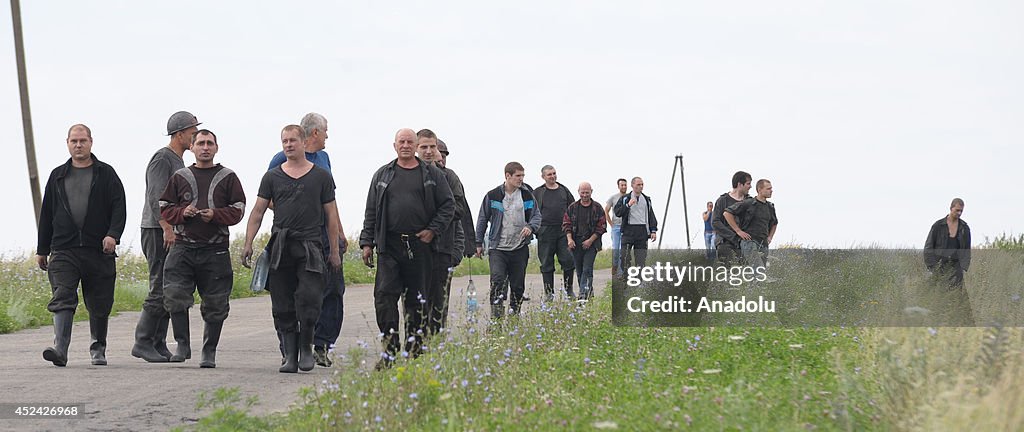 Experts inspect the wreckage of Malaysia Airlines plane