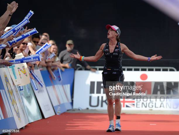 Tamsin Lewis of Britain celebrates winning the womens' race of the Ironman UK on July 20, 2014 in Bolton, England.