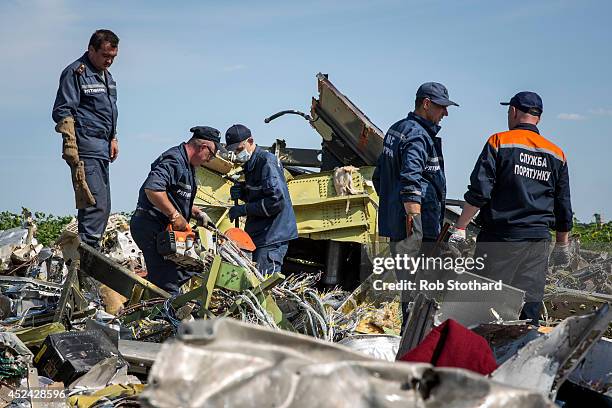 Ukrainian rescue servicemen inspect part of the wreckage of Malaysia Airlines flight MH17 on July 20, 2014 in Rassipnoye, Ukraine. Malaysia Airlines...