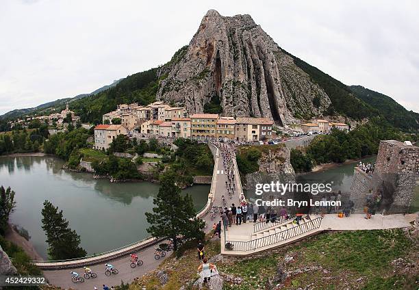 The peloton pass through Sisteron during the fifteenth stage of the 2014 Tour de France, a 222km stage between Tallard and Nimes, on July 20, 2014 in...