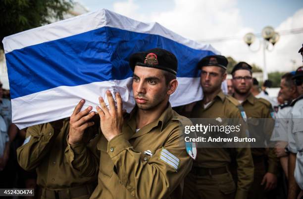 The casket carrying Israeli Sergeant Adar Barsano is carried to a burial plot in a cemetary during his funeral on July 20, 2014 in Nahariya, Israel....