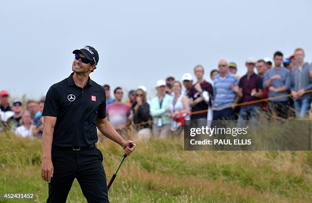 Australia's Adam Scott reacts after missing a putt on the 12th green during his fourth round, on the final day of the 2014 British Open Golf...