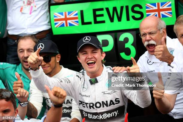 Nico Rosberg of Germany and Mercedes GP celebrates his victory with the team including CEO of Mercedes Dieter Zetsche and Lewis Hamilton of Great...