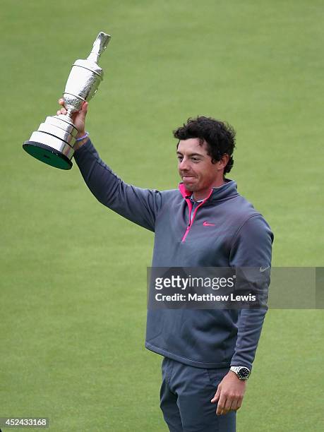 Rory McIlroy of Northern Ireland holds the Claret Jug aloft after his two-stroke victory at The 143rd Open Championship at Royal Liverpool on July...