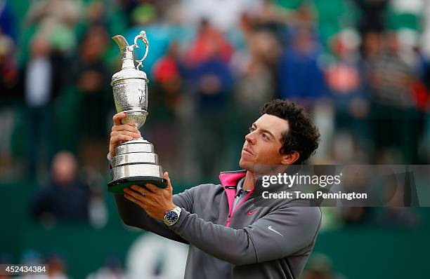 Rory McIlroy of Northern Ireland holds the Claret Jug aloft after his two-stroke victory at The 143rd Open Championship at Royal Liverpool on July...