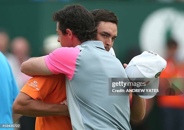 Golfer Rickie Fowler hugs Northern Ireland's Rory McIlroy on the 18th green after McIlroy wins the 2014 British Open Golf Championship at Royal...