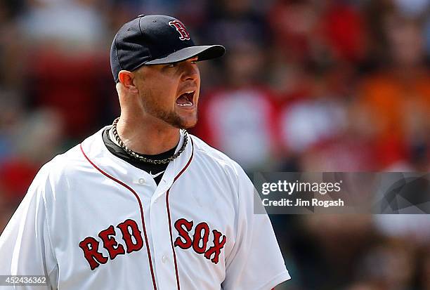 Jon Lester of the Boston Red Sox reacts after walking a man in the sixth inning against the Kansas City Royals at Fenway Park on July 20, 2014 in...
