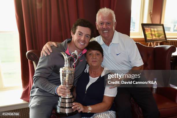 Rory McIlroy of Northern Ireland and his mom Rosie and father Gerry pose with the Claret Jug after his two-stroke victory in The 143rd Open...