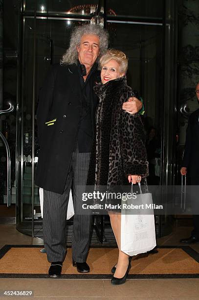 Brian May and Anita Dobson leaving The Langham Hotel on November 28, 2013 in London, England.