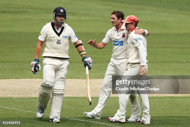 Chadd Sayers and Michael Klinger of the Redbacks celebrate the dismissal of John Holland of the Bushrangers during day one of the Sheffield Shield...