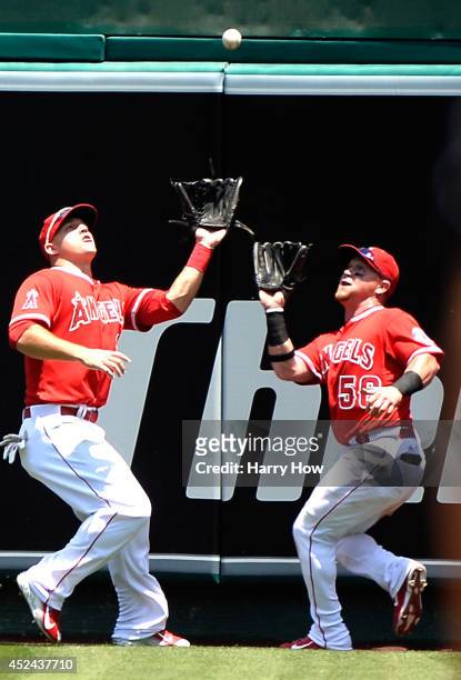 Mike Trout and Kole Calhoun of the Los Angeles Angels converge on a ball hit by Brad Miller of the Seattle Mariners for an out during the second...