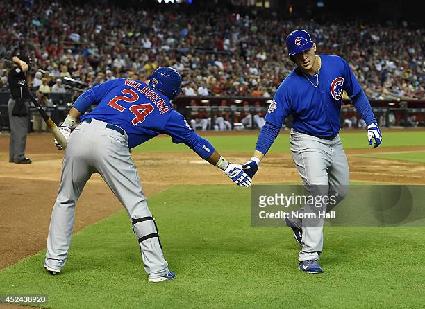 Anthony Rizzo of the Chicago Cubs celebrates a sixth inning home run with teammate Luis Valbuena against the Arizona Diamondbacks at Chase Field on...