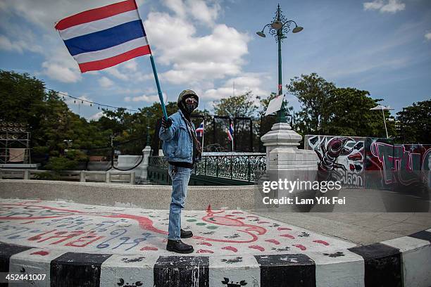 An anti-government protester takes part in a march at parliament on November 29, 2013 in Bangkok, Thailand. Anti-government protesters in Bangkok say...