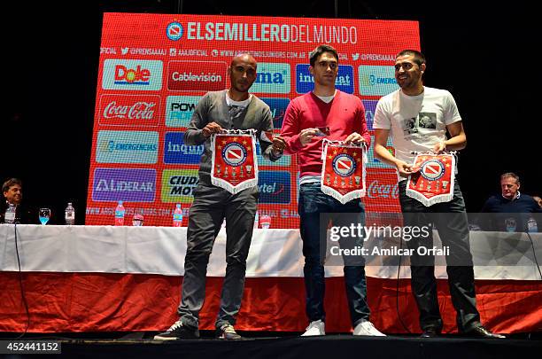 Cristian Ledesma, Matías Caruzzo and Juan Roman Riquelme pose for pictures during a press conference after the official unveiling of Juan Roman...