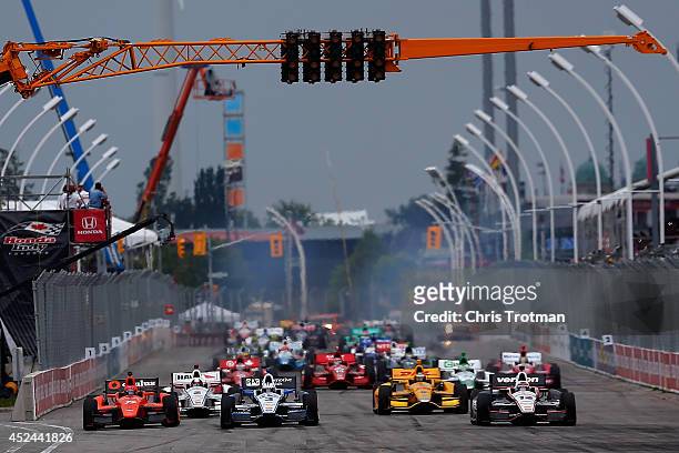 Helio Castroneves of Brazil driver of the Team Penske Dallara Chevrolet leads a pack of cars at the start of the Verizon IndyCar Series Honda Indy...
