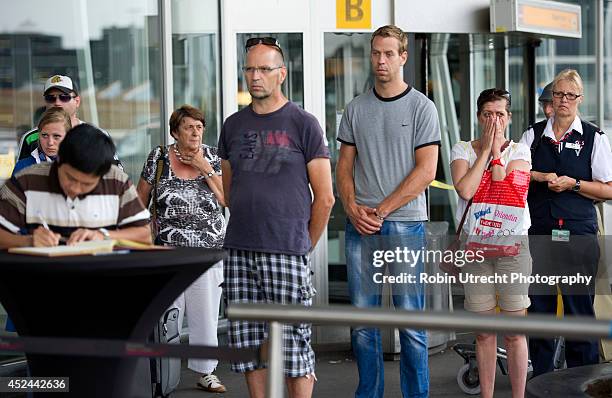 People view a makeshift memorial for the passengers aboard doomed flight Malaysia Airlines MH17 at Schiphol Airport July 20, 2014 in Amsterdam, the...