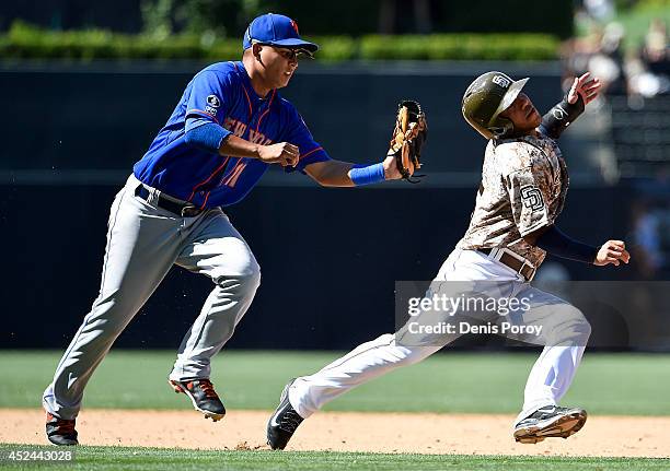 Alexi Amarista of the San Diego Padres is caught in a rundown by Ruben Tejada of the New York Mets during the ninth inning of a baseball game at...