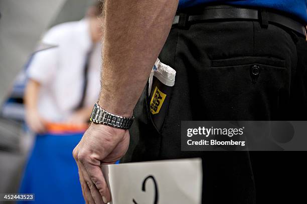 Promotional circular sticks out from the pocket of an employee at a Best Buy Co. Store ahead of Black Friday in Peoria, Illinois, U.S., on Thursday,...