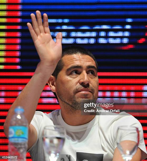 Juan Roman Riquelme greets during a press conference after his official unveiling as a new Argentinos Jrs player at Panamericano Hotel on July 20,...