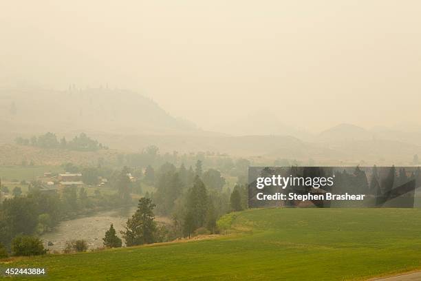 Smoke from the Carlton complex of fires covers Methow Valley on July 20, 2014 near Twisp, Washington. Several fires throughout the state have...