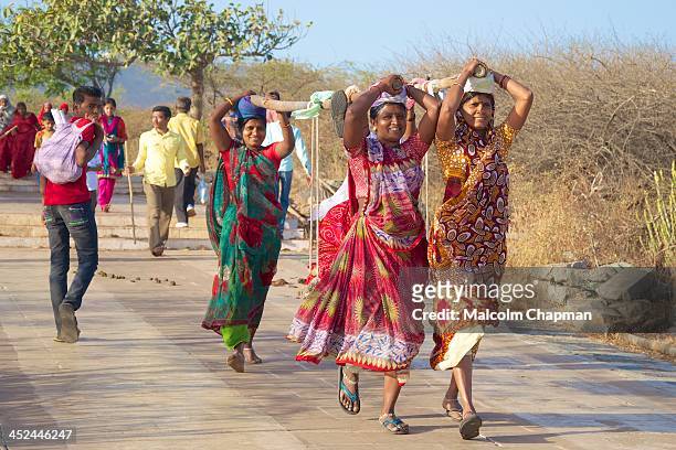 Female 'Doolie' workers carry a Jain pilgrim up Mount Satrunjaya meaning "place of victory", Palitana on MARCH 2, 2012. The temples, shrines and...