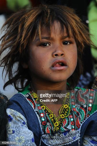 An Afghan child looks on as performers from The Mobile Mini Circus for Children take part in a circus show in Kabul on November 29, 2013. The Mobile...