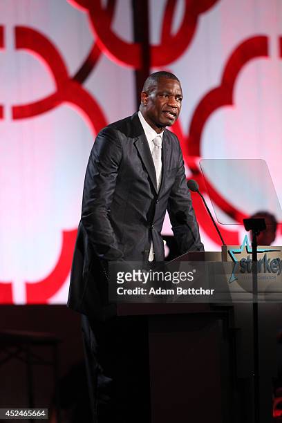 Dikembe Mutombo takes the stage at the 2014 Starkey Hearing Foundation So The World May Hear Gala at the St. Paul RiverCentre on July 20, 2014 in St....