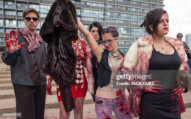 Israeli anti-fur activists take part in a fake fashion show during the Worldwide Fur Free Friday initiated by the international Anti-Fur coalition to...