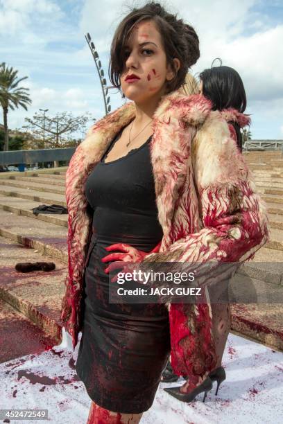 An Israeli anti-fur activist takes part in a fake fashion show during the Worldwide Fur Free Friday initiated by the international Anti-Fur coalition...