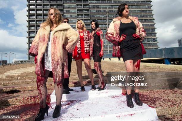 Israeli anti-fur activists take part in a fake fashion show during the Worldwide Fur Free Friday initiated by the international Anti-Fur coalition to...