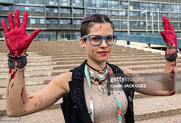 An Israeli anti-fur activist takes part in a fake fashion show during the Worldwide Fur Free Friday initiated by the international Anti-Fur coalition...