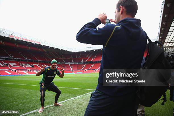 Johnathan Thurston poses on the pitch as Cameron Smith takes a photograph on his mobile phone ahead of the Australia training session at Old Trafford...