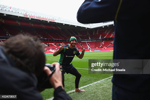 Johnathan Thurston poses on the pitch as Cameron Smith takes a photograph on his mobile phone ahead of the Australia training session at Old Trafford...