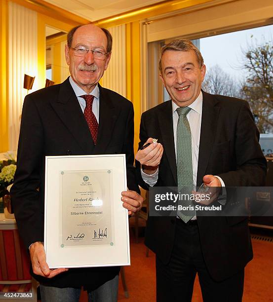 President Wolfgang Niersbach presents Herbert Roesch, president of the Baden-Wuertemberg football association with the Silberne Ehrennadel prior to...