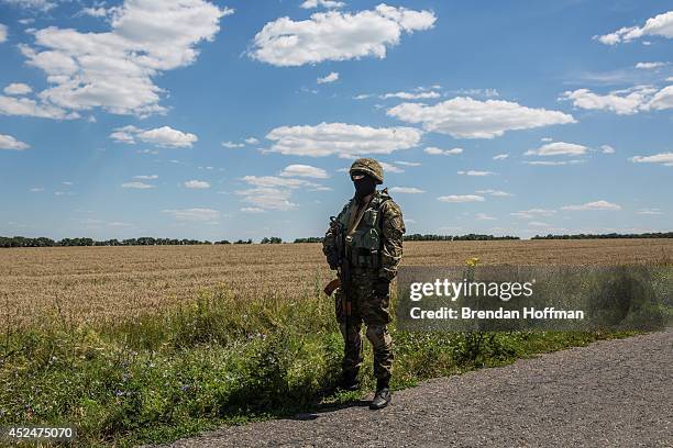 An unidentified member of the security detail for inspectors from the Organization for Security and Cooperation in Europe and the Dutch government...