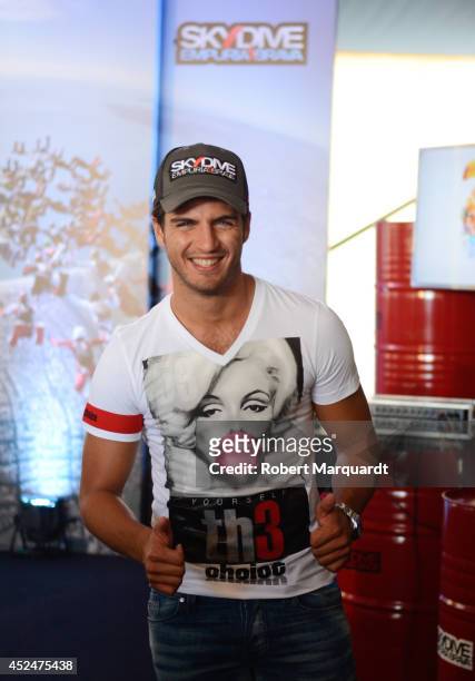 Spanish actor Maxi Iglesias poses as he inaugurates "Beach Festival and King of Swoop 2014" on July 21, 2014 in Barcelona, Spain.