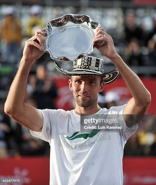 Ivo Karlovic of Coatia, raise the trophy after finishing second during a tennis match between Ivo Karlovic of Croatia and Bernard Tomic of Australia...