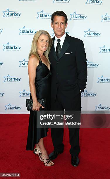 James Denton and guest walk the red carpet at the 2014 Starkey Hearing Foundation So The World May Hear Gala at the St. Paul RiverCentre on July 20,...