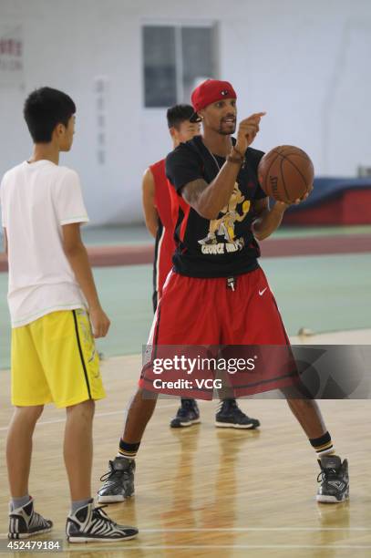 Player George Hill coaches students at George Hill China Basketball Training Center on July 20, 2014 in Zhengzhou, Henan province of China.