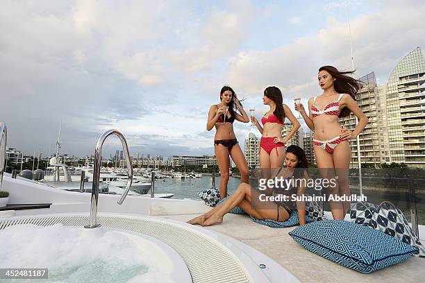 Models showcase designs by Honey Birdette on board a super yacht at the ONE¡15 Marina Club in Sentosa on November 29, 2013 in Singapore.
