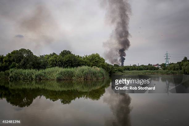 Smoke rises from a buliding damaged during fighting between pro-Russia rebels and Ukrainian government troops on July 21, 2014 in Donetsk, Ukraine....