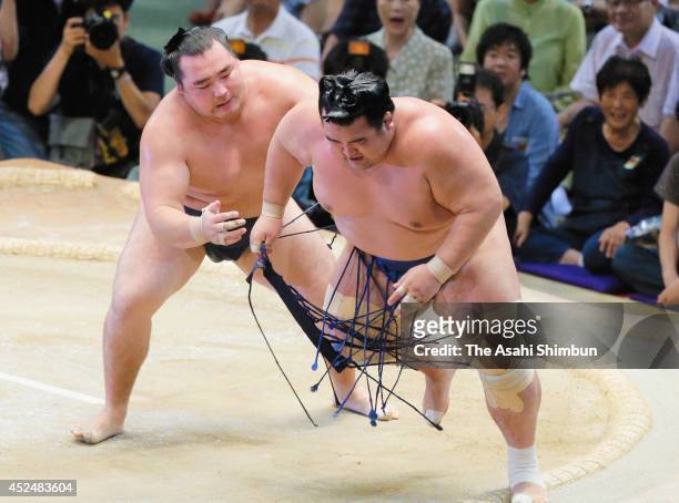 Yokozuna Kakuryu sends out ozeki Kotoshogiku to win during day nine of the Grand Sumo Nagoya Tournament at Aichi Prefecture Gymnasium on July 21,...