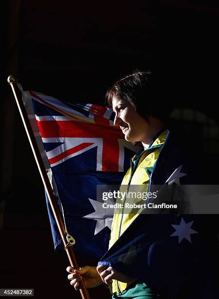 Anna Meares of Australia poses with the Australian flag after she was announced as the flag bearer for the opening ceremony, during the Austrlian...