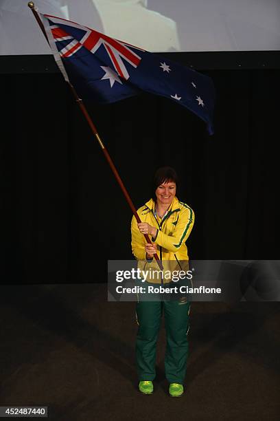 Anna Meares of Australia poses with the Australian flag after she was announced as the flag bearer for the opening ceremony, during the Austrlian...